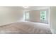 Spacious bedroom with neutral carpet, natural light and a view of the landscape at 3213 Mcharney Dr # 32, Harrisburg, NC 28075