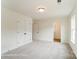 Spacious bedroom featuring plush carpeting, ample natural light from windows, and a double-door closet at 3213 Mcharney Dr # 32, Harrisburg, NC 28075