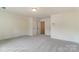 Expansive bedroom featuring neutral walls and carpet, complemented by a connecting door to another room at 3213 Mcharney Dr # 32, Harrisburg, NC 28075
