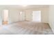 Spacious living area with neutral colored carpet and an open floor plan at 3213 Mcharney Dr # 32, Harrisburg, NC 28075