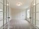 Office space with carpet flooring, neutral paint, double doors and large windows for natural light at 3213 Mcharney Dr # 32, Harrisburg, NC 28075