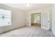 Bright room with white walls, carpet flooring, and a view of the neighborhood through large windows at 3213 Mcharney Dr # 32, Harrisburg, NC 28075