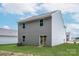 Home back exterior with a large backyard, sliding glass door to the exterior, and gray siding at 3263 Maple Ridge Dr, Gastonia, NC 28052