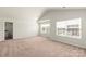 Bright, carpeted bedroom includes two windows and an ensuite bathroom at 3263 Maple Ridge Dr, Gastonia, NC 28052