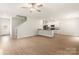 Spacious living room with an open floor plan, hardwood floors, and a ceiling fan at 3263 Maple Ridge Dr, Gastonia, NC 28052