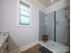 Modern bathroom featuring a glass shower with tiled walls and a small window above the sink at 3528 Thunder Rd, Maiden, NC 28650