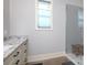 Modern bathroom with a glass shower, granite countertop, window and a wooden stool at 3528 Thunder Rd, Maiden, NC 28650