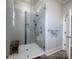 Modern bathroom featuring a tiled glass shower with a bench and a wall-mounted towel rack at 3528 Thunder Rd, Maiden, NC 28650