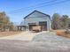 Wide shot of a single Gathering home with a long driveway leading to a two-car garage and covered porch at 3528 Thunder Rd, Maiden, NC 28650