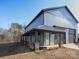 Home exterior with a stylish porch, stone pillars, and a convenient side garage at 3528 Thunder Rd, Maiden, NC 28650