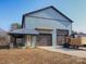 View of the attractive blue two-story home with a covered porch and large garage doors at 3528 Thunder Rd, Maiden, NC 28650