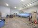 Well-lit garage with a boat on a trailer and storage shelves, perfect for vehicle and equipment maintenance at 3528 Thunder Rd, Maiden, NC 28650