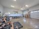 Spacious garage featuring a light blue boat on a trailer and two garage doors at 3528 Thunder Rd, Maiden, NC 28650