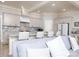 A modern kitchen featuring white cabinets, an island, bar stool seating, and stainless appliances at 3528 Thunder Rd, Maiden, NC 28650
