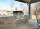 Outdoor kitchen with a built-in grill, set in a beautiful covered patio area for the ultimate entertainment experience at 3528 Thunder Rd, Maiden, NC 28650