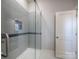 This modern shower features sleek glass doors, grey tiled walls, and a built-in niche for added convenience and style at 3528 Thunder Rd, Maiden, NC 28650