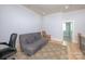 Cozy sitting room with warm wood floors, a comfortable futon, chair, and a view to the adjacent office at 3528 Thunder Rd, Maiden, NC 28650