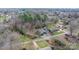 An aerial view of a home with a long driveway surrounded by trees, outbuildings and a large lawn at 406 Third Ne Ave, Conover, NC 28613
