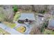 Aerial view of a home with a large wooden deck, surrounding trees, and gravel driveway at 406 Third Ne Ave, Conover, NC 28613