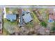 Wide aerial shot of a home surrounded by trees and a stream, featuring a well-maintained yard and ample space at 406 Third Ne Ave, Conover, NC 28613