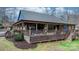 Expansive back porch featuring wood decking, ceiling fans, an outdoor kitchen and comfortable seating areas at 406 Third Ne Ave, Conover, NC 28613