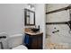 Bathroom boasts a granite vanity, black bowl sink, tiled shower with a built-in bench and a rainfall shower at 406 Third Ne Ave, Conover, NC 28613