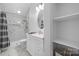 The renovated bathroom features a glass shower, oval mirror, storage shelves, and marble tile at 406 Third Ne Ave, Conover, NC 28613