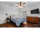 A cozy bedroom features a queen-sized bed, hardwood floors, a ceiling fan, and natural light at 406 Third Ne Ave, Conover, NC 28613