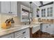 This kitchen boasts a farmhouse sink, granite countertops, and a mosaic tile backsplash at 406 Third Ne Ave, Conover, NC 28613