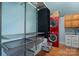 A tidy laundry room features a stacked washer and dryer, shelving units, a sink, and wooden floors at 406 Third Ne Ave, Conover, NC 28613