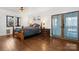Bright main bedroom with hardwood floors, side tables with lamps, and door to the balcony at 406 Third Ne Ave, Conover, NC 28613