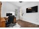 Office with hardwood floors, computer, wooden desk, and a large TV at 406 Third Ne Ave, Conover, NC 28613