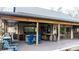 Spacious covered outdoor kitchen featuring stainless steel appliances, bar seating and dark wood accents at 406 Third Ne Ave, Conover, NC 28613