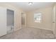 Bright bedroom features neutral carpet, a window, and a door leading to an ensuite bathroom at 417 Baker Street Ext, Rock Hill, SC 29730
