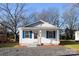 Charming cottage-style home featuring a classic white exterior with blue shutter accents, and a landscaped front yard at 417 Baker Street Ext, Rock Hill, SC 29730