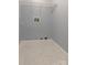 Tiled laundry room with white trim, wire shelving, and utility hookups at 417 Baker Street Ext, Rock Hill, SC 29730