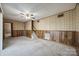 Spacious living room featuring wood paneling and a staircase at 5082 Mariana Ct, Tega Cay, SC 29708