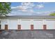 Row of detached garages with white doors and brick accents at 537 Southeast Dr # 537, Davidson, NC 28036