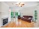 Living room with fireplace, hardwood floors, and sliding door to outdoor living area at 537 Southeast Dr # 537, Davidson, NC 28036