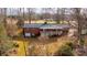 Aerial view of a brick home featuring a back deck and a detached garage in a wooded setting at 6000 George Hildebran School Rd, Hickory, NC 28602
