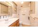 Traditional bathroom featuring a standalone shower, wood vanity, decorative wallpaper and updated sink at 6000 George Hildebran School Rd, Hickory, NC 28602