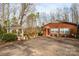 Quaint brick home with an adjacent gazebo, complemented by lush landscaping and a spacious driveway at 6000 George Hildebran School Rd, Hickory, NC 28602