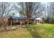 Charming brick home featuring a well-maintained lawn, mature landscaping, and an inviting entrance at 6000 George Hildebran School Rd, Hickory, NC 28602