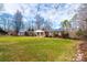 Charming brick home with a well-manicured lawn, mature trees, and a welcoming front porch at 6000 George Hildebran School Rd, Hickory, NC 28602