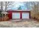 Red two-car garage with a white garage door and a classic well, offering ample parking and storage at 6000 George Hildebran School Rd, Hickory, NC 28602