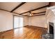 Bright living room featuring hardwood floors, a fireplace, and access to the backyard at 6000 George Hildebran School Rd, Hickory, NC 28602