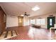 Spacious living room featuring unique brick flooring, large windows, ceiling fan, and neutral color palette at 6000 George Hildebran School Rd, Hickory, NC 28602