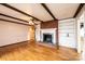 Spacious living room featuring a brick fireplace, built-in shelving, and hardwood floors at 6000 George Hildebran School Rd, Hickory, NC 28602
