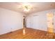 Bedroom with hardwood floors, a ceiling fan, and access to an ensuite bathroom at 6000 George Hildebran School Rd, Hickory, NC 28602