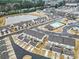 Aerial view of townhouses in a community, featuring a swimming pool and a scenic pond in the background at 6814 Piper Thorn Way, Indian Land, SC 29707